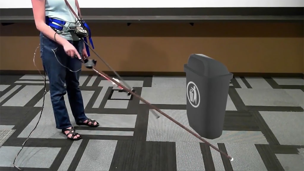 Инженеры компании Microsoft разработали устройство в помощь слепым и слабовидящим людям на основе VR-технологии. Специальная трость, дополненная трекером и VR-шлемом, позволяет воссоздать в виртуальной реальности физическое пространство. Взаимодействуя с виртуальными объектами трость издает привычные человеку звуки, имитируя столкновение с пластмассой, камнем, деревом и так далее